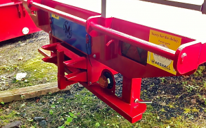 Marshall flat agricultural bale trailer with loading ramps and stands for loading a digger.